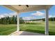 Covered porch with a beautiful green lawn and lush trees in the backyard at 326 Umstead St, Sanford, NC 27330
