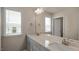 Bathroom vanity featuring double sinks, a large mirror, and neutral paint at 326 Umstead St, Sanford, NC 27330