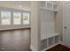 Entryway with storage cubes and coat hooks next to a living room with lots of light at 326 Umstead St, Sanford, NC 27330