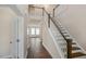 Bright foyer with hardwood floors, staircase, and paneled doors at 326 Umstead St, Sanford, NC 27330