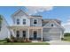 Charming two-story home with gray siding, covered porch, and manicured lawn at 326 Umstead St, Sanford, NC 27330