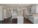 Bright kitchen features an island, stainless steel appliances, gray cabinets, and an eat-in breakfast area at 326 Umstead St, Sanford, NC 27330