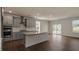 Open concept kitchen featuring gray cabinets, stainless steel appliances, and a kitchen island at 326 Umstead St, Sanford, NC 27330