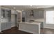 Modern kitchen featuring gray cabinets, stainless steel appliances, and a center island at 326 Umstead St, Sanford, NC 27330