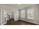 Open living room with hardwood floors, white trim, and double French doors at 326 Umstead St, Sanford, NC 27330