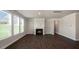 A new living room with hardwood floors has a fireplace and gets lots of light from big windows at 326 Umstead St, Sanford, NC 27330