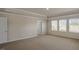 Large main bedroom with neutral carpet and bright light from big windows at 326 Umstead St, Sanford, NC 27330