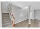 Spacious foyer featuring wood-look floors, neutral walls, and a staircase to the second floor at 3408 Dutchman Rd, Raleigh, NC 27610