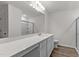 Bathroom featuring wood-look flooring, white cabinets, a vanity with double sinks, and a shower at 40 Rolling Banks Dr, Louisburg, NC 27549