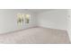 Spacious bedroom filled with natural light from the two large windows, and neutral carpet at 40 Rolling Banks Dr, Louisburg, NC 27549