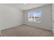 Bright bedroom featuring a large window and neutral carpet at 40 Rolling Banks Dr, Louisburg, NC 27549