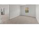 Bright bedroom with neutral carpet and paint features a window offering views of the outdoors at 40 Rolling Banks Dr, Louisburg, NC 27549