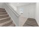 Bright entryway showcasing stairs, neutral carpet, and wood-look vinyl flooring at 40 Rolling Banks Dr, Louisburg, NC 27549