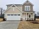 Charming two-story home featuring a two-car garage, landscaped yard, and traditional design elements at 40 Rolling Banks Dr, Louisburg, NC 27549