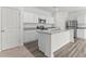 Modern kitchen featuring white cabinets, stainless steel appliances, an island, and granite countertops at 40 Rolling Banks Dr, Louisburg, NC 27549