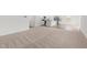 Open-concept living room featuring neutral carpets and views into the kitchen at 40 Rolling Banks Dr, Louisburg, NC 27549