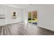 Open-concept living area with wood-look flooring features sliding glass doors leading to the backyard at 40 Rolling Banks Dr, Louisburg, NC 27549
