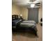 Comfortable bedroom with a ceiling fan, carpeted floors and natural light at 421 Angus Pl, Stem, NC 27581