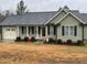 Charming single-story home with a garage, a front yard, and traditional curb appeal at 421 Angus Pl, Stem, NC 27581
