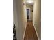 Hallway with hardwood floors, neutral walls and view into a bedroom at 421 Angus Pl, Stem, NC 27581