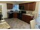 Well-equipped kitchen with dark cabinets, granite countertops, and black appliances at 421 Angus Pl, Stem, NC 27581