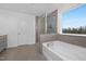 Elegant bathroom features a soaking tub, tiled shower, and dual sink vanity with a window view at 43 Mable Court # 4, Lillington, NC 27546