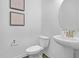 Stylish powder room featuring modern fixtures, framed artwork, and a pedestal sink at 43 Mable Court # 4, Lillington, NC 27546