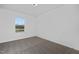 Bedroom featuring gray carpet and a large window for natural light and scenic views at 43 Mable Court # 4, Lillington, NC 27546