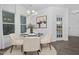 Cozy dining area with round table, elegant seating, modern chandelier, and lots of natural light at 43 Mable Court # 4, Lillington, NC 27546