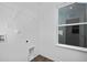 Practical laundry room featuring wood-look flooring, wire shelving, and a window for natural light at 43 Mable Court # 4, Lillington, NC 27546