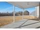This screened porch has ample space and a nice view of the backyard with brown grass at 43 Mable Court # 4, Lillington, NC 27546