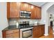 Close up of a kitchen featuring stainless steel appliances and dark granite countertops at 5006 Celtic Ct, Raleigh, NC 27612