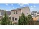 Back exterior features second story windows, patio and pond views, and landscaped backyard at 532 Smithridge Way, Fuquay Varina, NC 27526