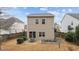 Back exterior showing patio, pond and sliding glass door for backyard access, surrounded by a wood fence at 532 Smithridge Way, Fuquay Varina, NC 27526