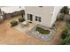 Aerial view of a backyard with a patio, dining table, and a serene pond, perfect for outdoor relaxation at 532 Smithridge Way, Fuquay Varina, NC 27526