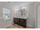 Bathroom with dual sink vanity, tiled floor, and a large mirror for a clean, modern look at 532 Smithridge Way, Fuquay Varina, NC 27526