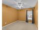 This bedroom features a ceiling fan, light carpet, window and neutral paint, offering a cozy and inviting space at 532 Smithridge Way, Fuquay Varina, NC 27526