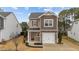 Charming two-story home with a stone-accented garage, red front door and manicured landscaping at 532 Smithridge Way, Fuquay Varina, NC 27526