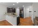 Modern kitchen featuring dark cabinets, granite countertops, and stainless steel appliances at 532 Smithridge Way, Fuquay Varina, NC 27526