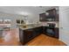 Modern kitchen featuring dark cabinets, granite countertops, and stainless steel appliances at 532 Smithridge Way, Fuquay Varina, NC 27526