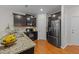 Modern kitchen featuring dark cabinets, granite countertops, and stainless steel appliances at 532 Smithridge Way, Fuquay Varina, NC 27526