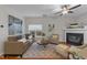 Cozy living room with a fireplace, ceiling fan, and modern decor at 532 Smithridge Way, Fuquay Varina, NC 27526