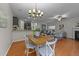 Open-concept living spaces with hardwood floors, seamlessly connecting the dining area and living room at 532 Smithridge Way, Fuquay Varina, NC 27526
