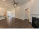 Open living room featuring a fireplace, ceiling fan, and hardwood flooring at 56 Cooper Branch Ct, Fuquay Varina, NC 27526