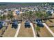 An aerial view shows several homes in a community with large yards and paved driveways at 594 Executive Dr, Lillington, NC 27546