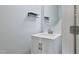 Elegant half-bathroom with white vanity, oval mirror, and modern fixtures at 594 Executive Dr, Lillington, NC 27546