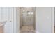 Bathroom featuring large tiled walk-in shower with glass door at 594 Executive Dr, Lillington, NC 27546