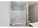 Shower and bathtub combination with an adjustable shower head and a gray tile accent at 594 Executive Dr, Lillington, NC 27546