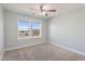 Comfortable bedroom with neutral carpet, two windows, and ceiling fan at 594 Executive Dr, Lillington, NC 27546