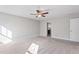 Bright and airy bedroom with neutral carpet and ceiling fan at 594 Executive Dr, Lillington, NC 27546